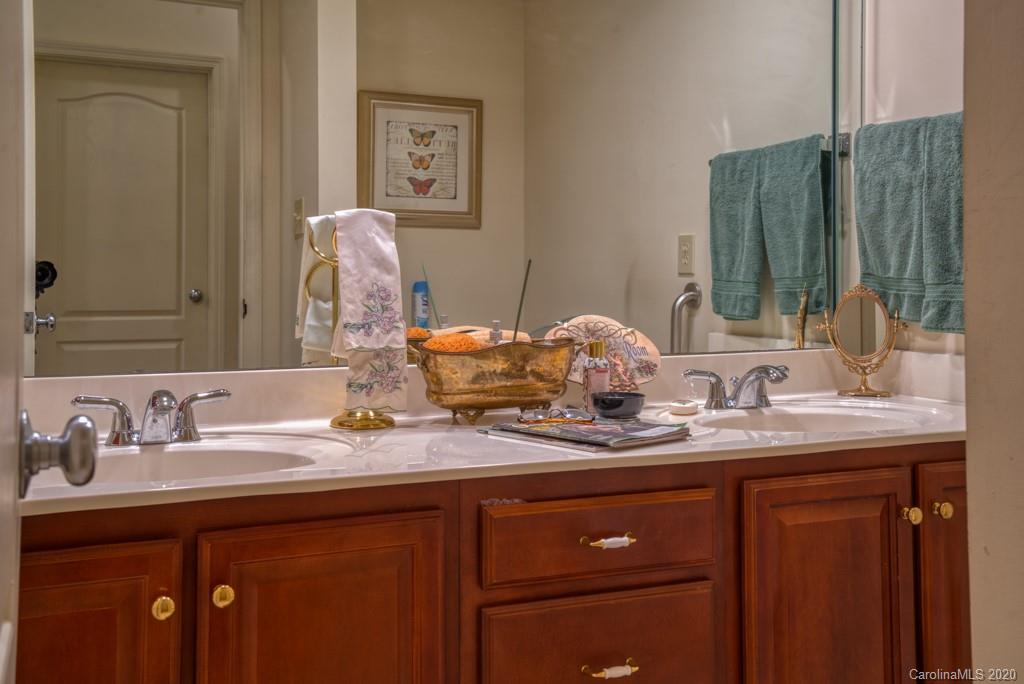 77 Club Road Tryon, NC 28782 - Photo 27 of 35 a bathroom with a granite countertop sink and a mirror