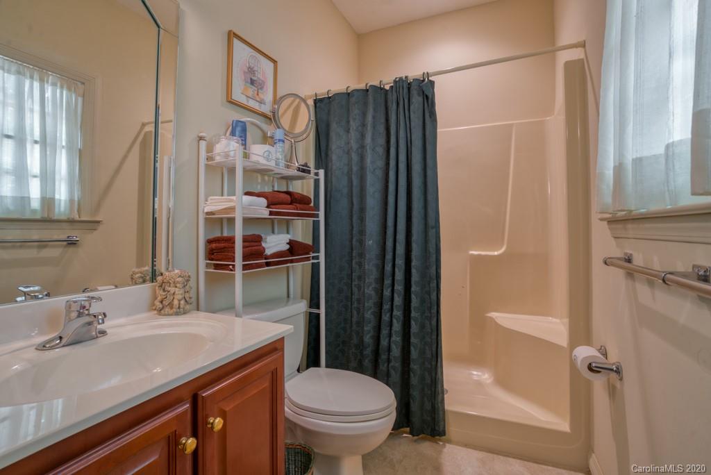 77 Club Road Tryon, NC 28782 - Photo 35 of 35 a bathroom with a granite countertop sink toilet and shower