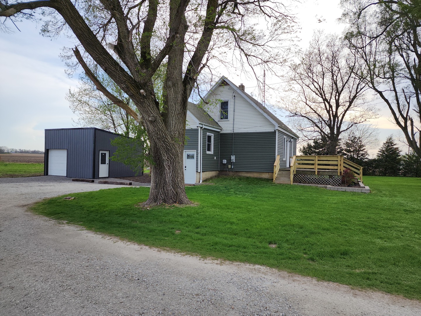 6522 East 3500S Road St. Anne, IL 60964 - Photo 19 of 20 a white house that has a tree in front of it