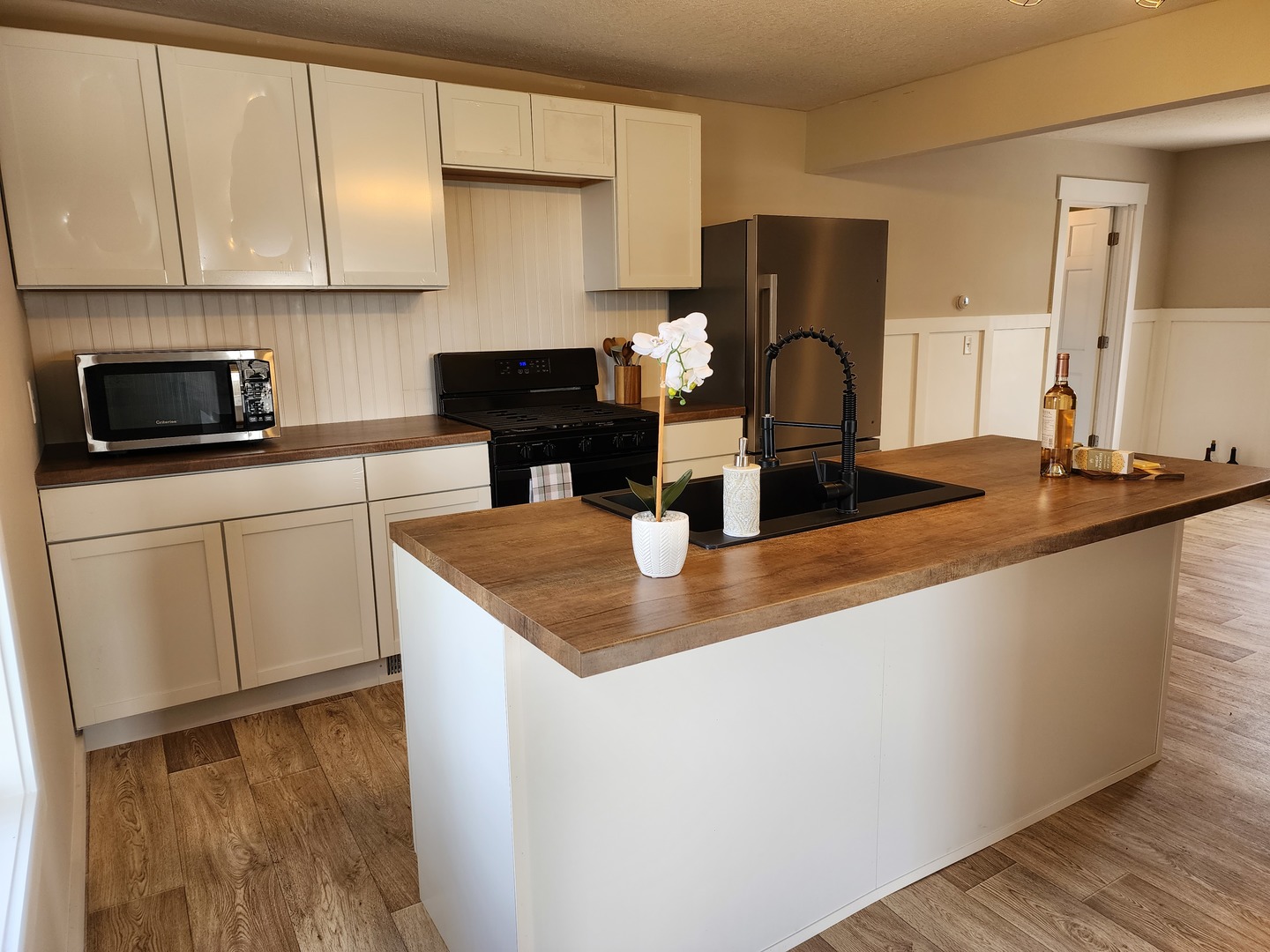 6522 East 3500S Road St. Anne, IL 60964 - Photo 2 of 20 a kitchen with sink a microwave and cabinets