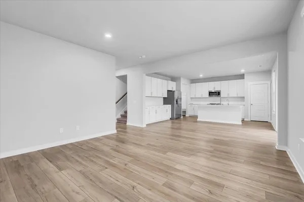 a view of a kitchen with a sink and a refrigerator