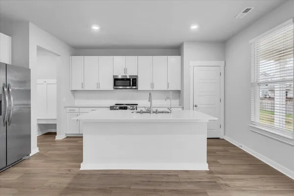 a kitchen with stainless steel appliances a sink stove and refrigerator