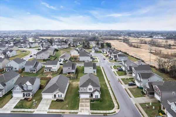 an aerial view of residential houses with city view