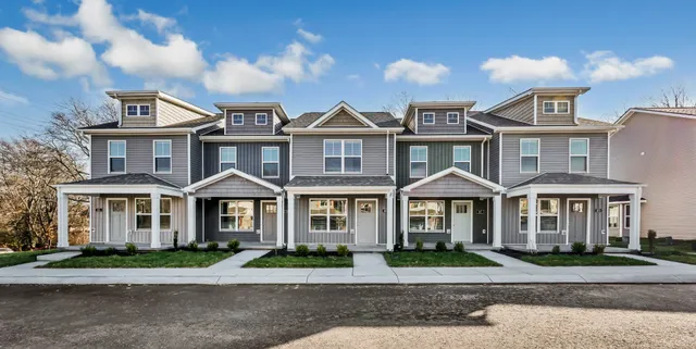 a front view of a residential apartment building with a yard