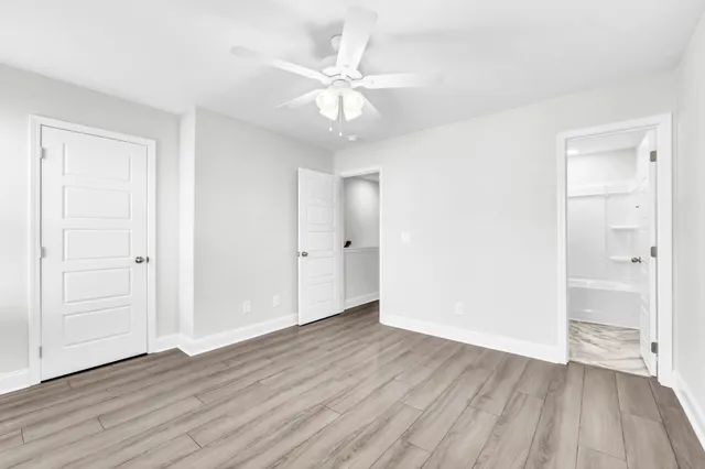 a bathroom with a granite countertop sink a toilet and shower