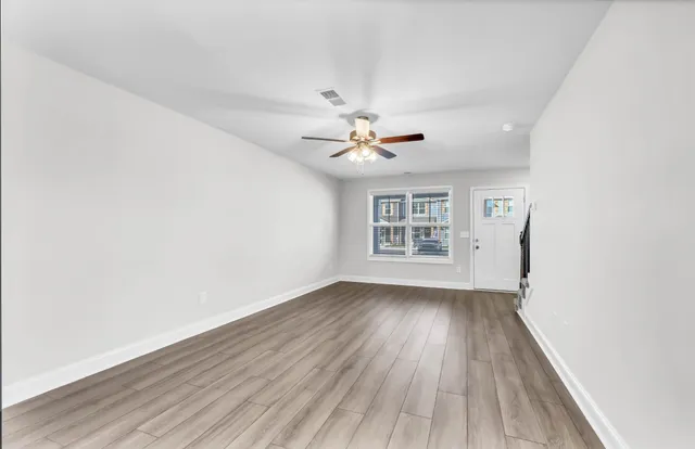 wooden floor in an empty room with a window