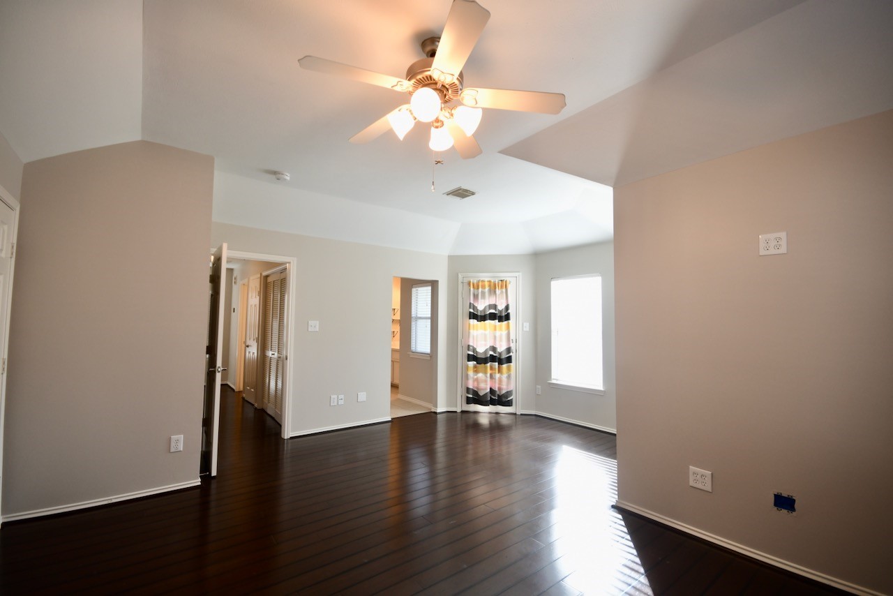 1706 Redwing Bluff Drive Houston, TX 77009 - Photo 13 of 24 a view of an empty room with window and wooden floor