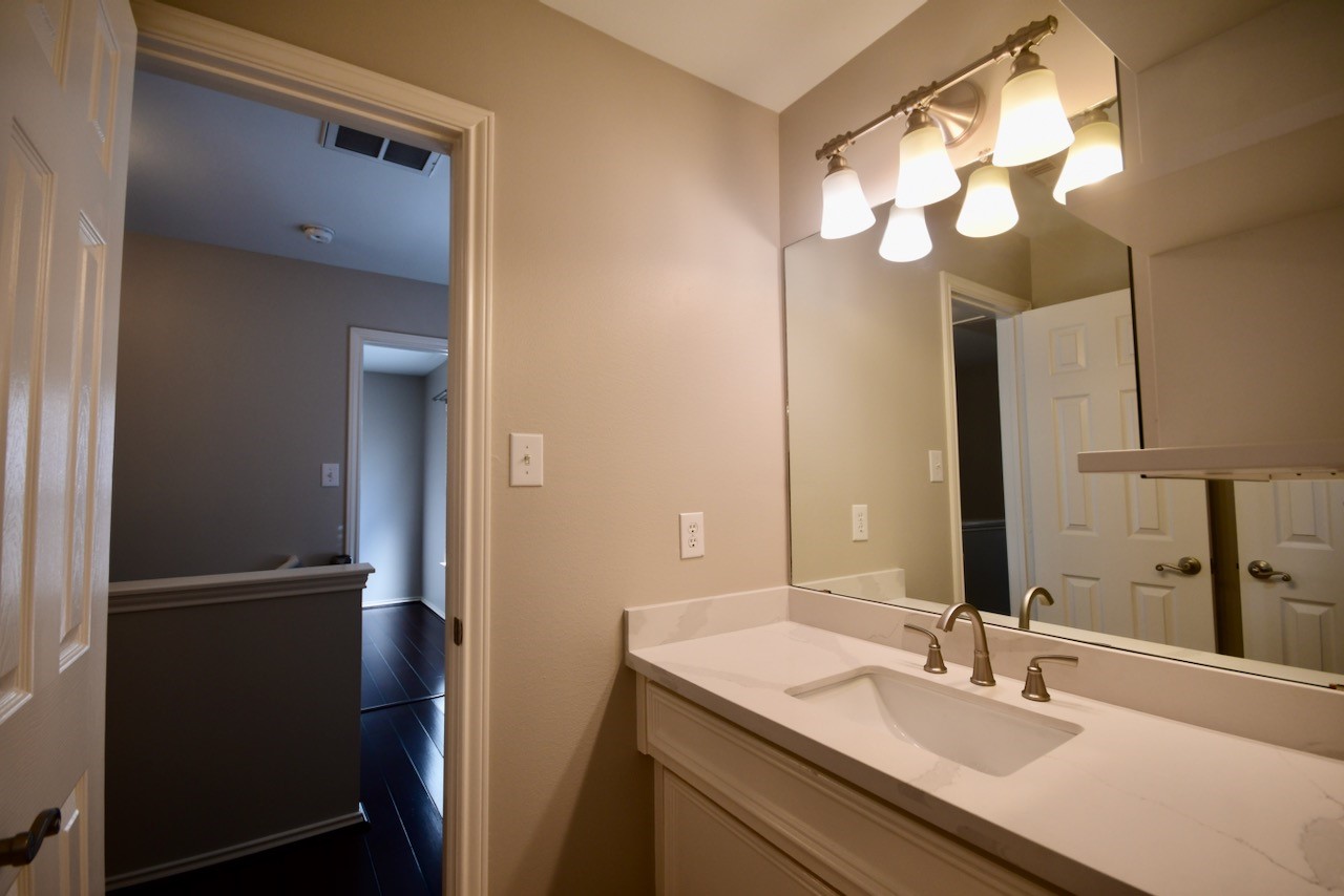 1706 Redwing Bluff Drive Houston, TX 77009 - Photo 17 of 24 a bathroom with a sink vanity and a mirror