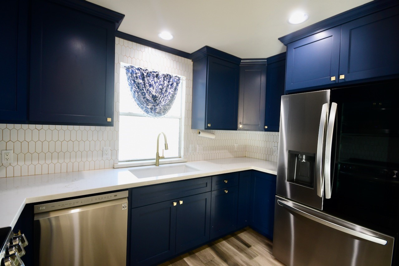1706 Redwing Bluff Drive Houston, TX 77009 - Photo 6 of 24 a kitchen with stainless steel appliances granite countertop a refrigerator and a sink