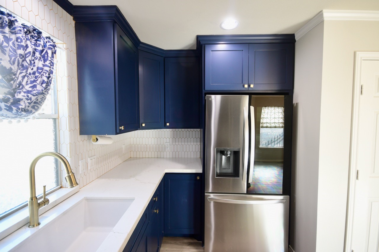 1706 Redwing Bluff Drive Houston, TX 77009 - Photo 7 of 24 a kitchen with a refrigerator and a sink