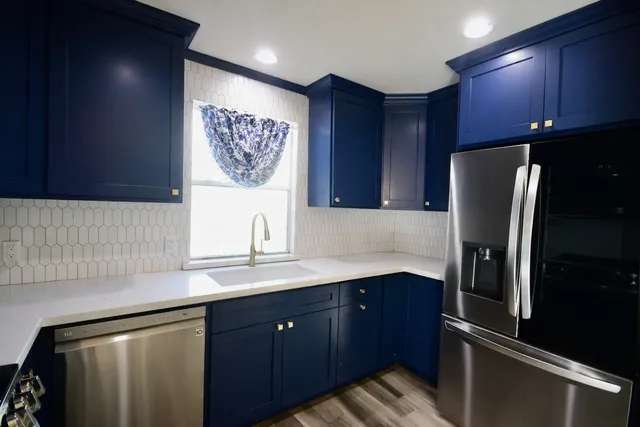 a kitchen with a refrigerator and a sink