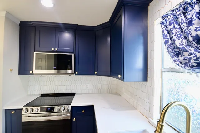 a kitchen with stainless steel appliances granite countertop a refrigerator and a sink