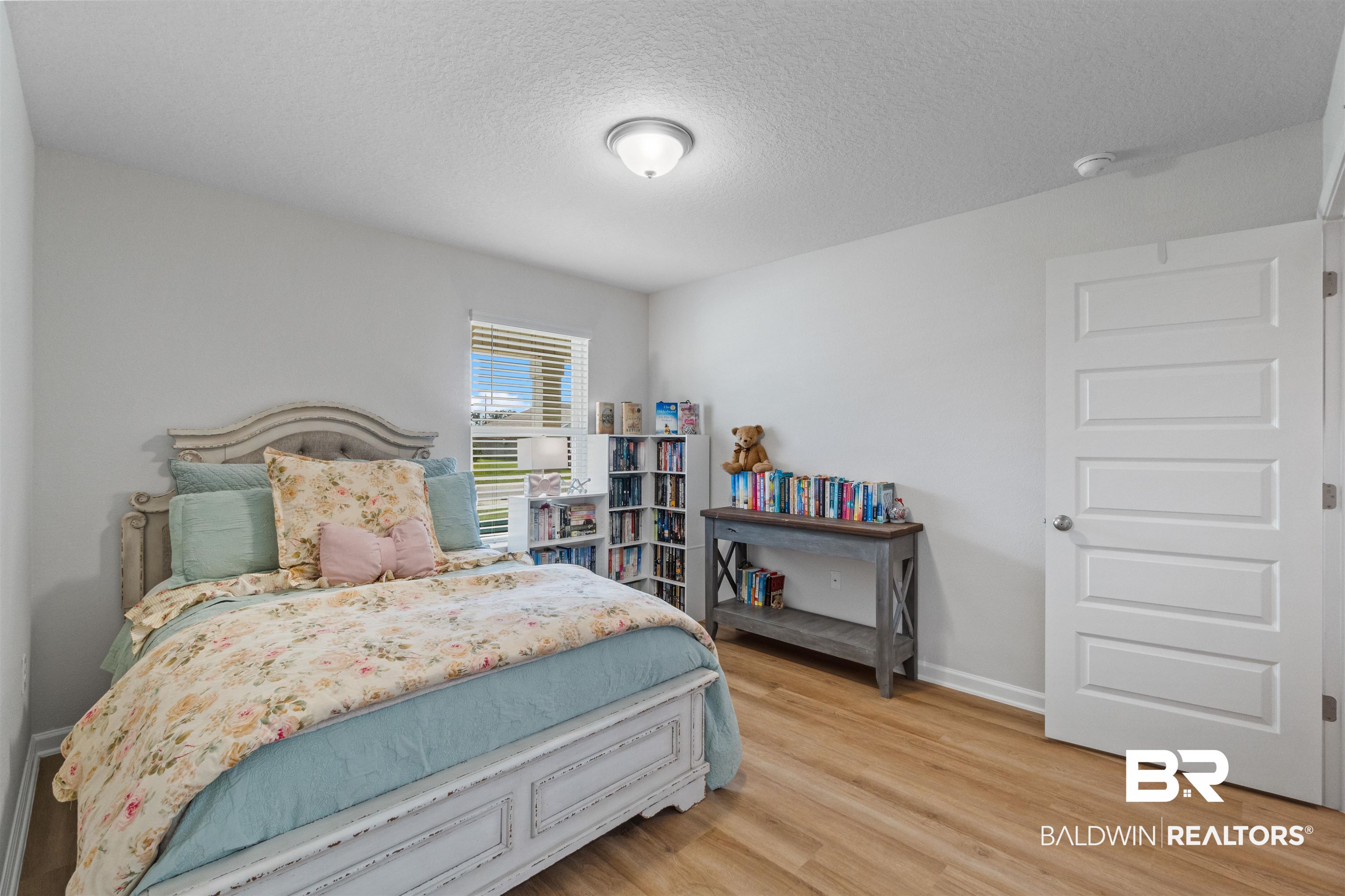 24390 Ringneck Loop Elberta, AL 36530 - Photo 29 of 39 Bedroom with a textured ceiling and light hardwood / wood-style floors