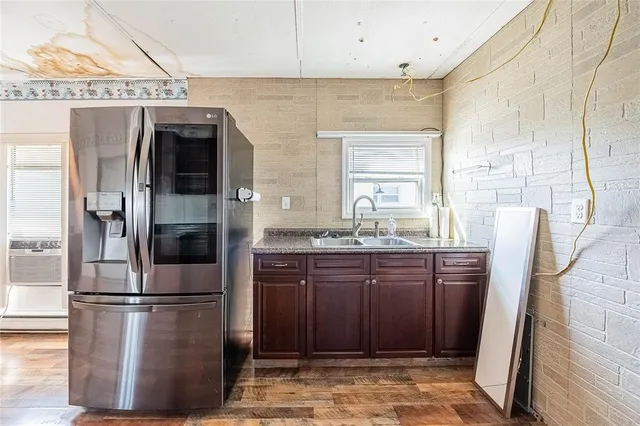a kitchen with stainless steel appliances granite countertop a refrigerator and a sink