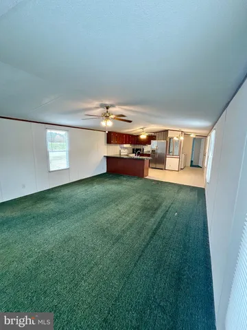 a view of a living room with a table and chairs