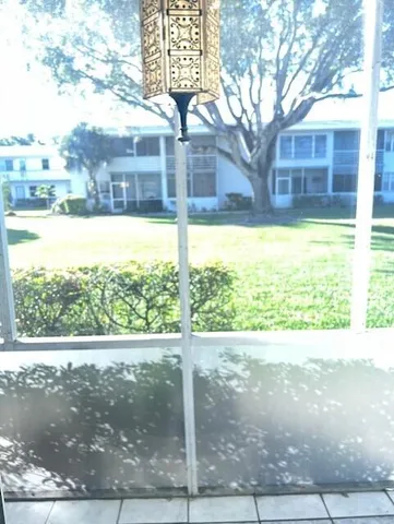 a view of a big house with a big yard and large tree