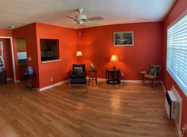 a room with wooden floor and furniture