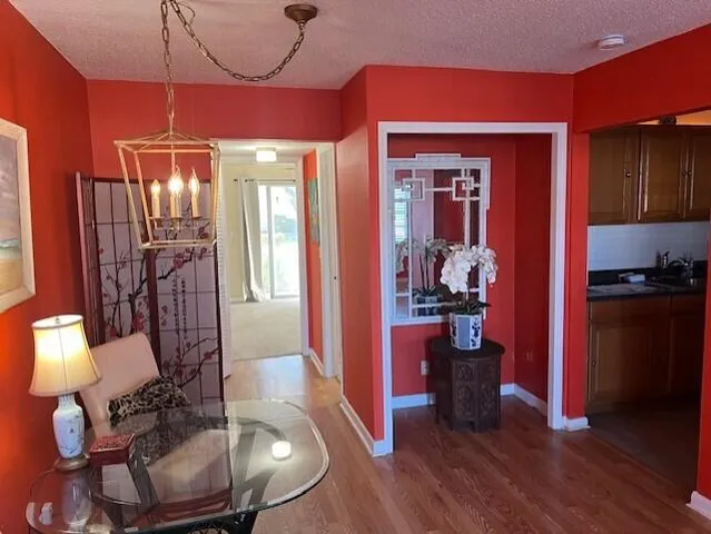 a kitchen with granite countertop a refrigerator stove and sink