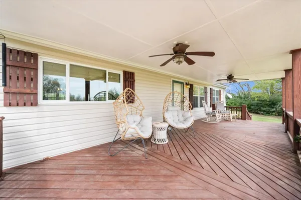 a view of a house with backyard and sitting area
