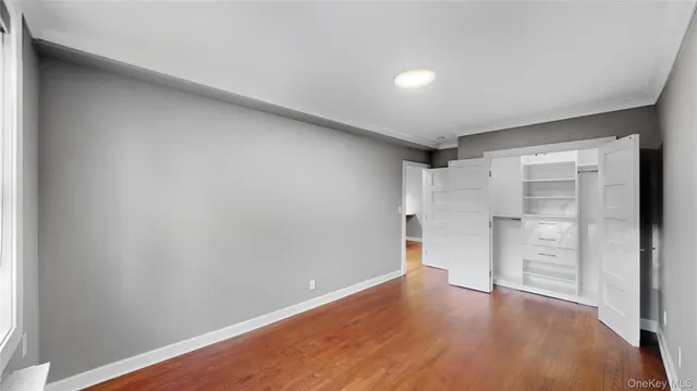 a view of walk in closet with empty racks