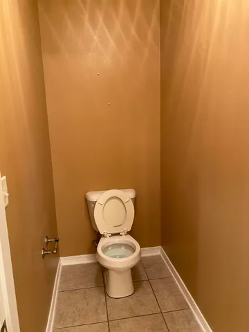 a white toilet sitting in a bathroom