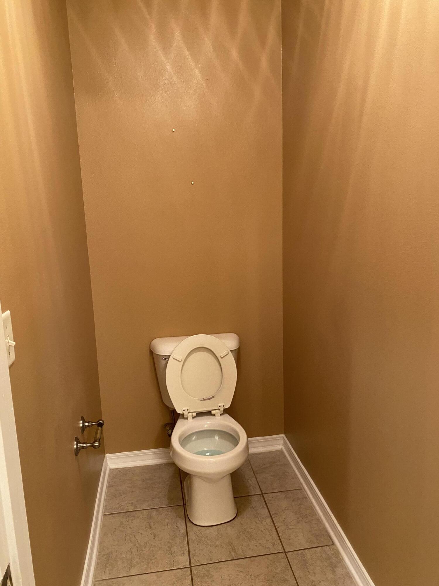 175 Beacon Way Miramar Beach, FL 32550 - Photo 15 of 26 a white toilet sitting in a bathroom