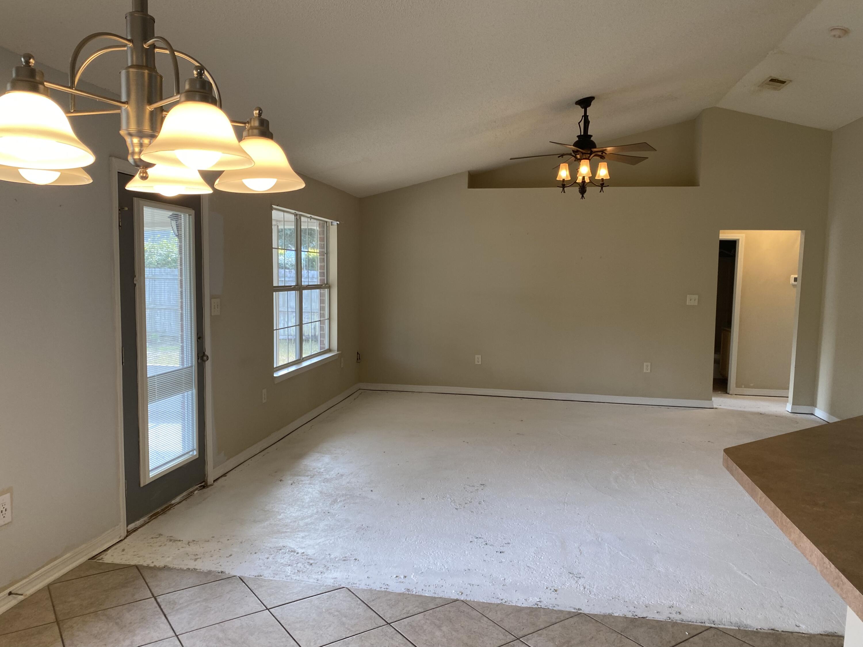 175 Beacon Way Miramar Beach, FL 32550 - Photo 4 of 26 an empty room with chandelier fan and windows