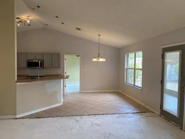 a view of a kitchen with a sink dishwasher and fireplace