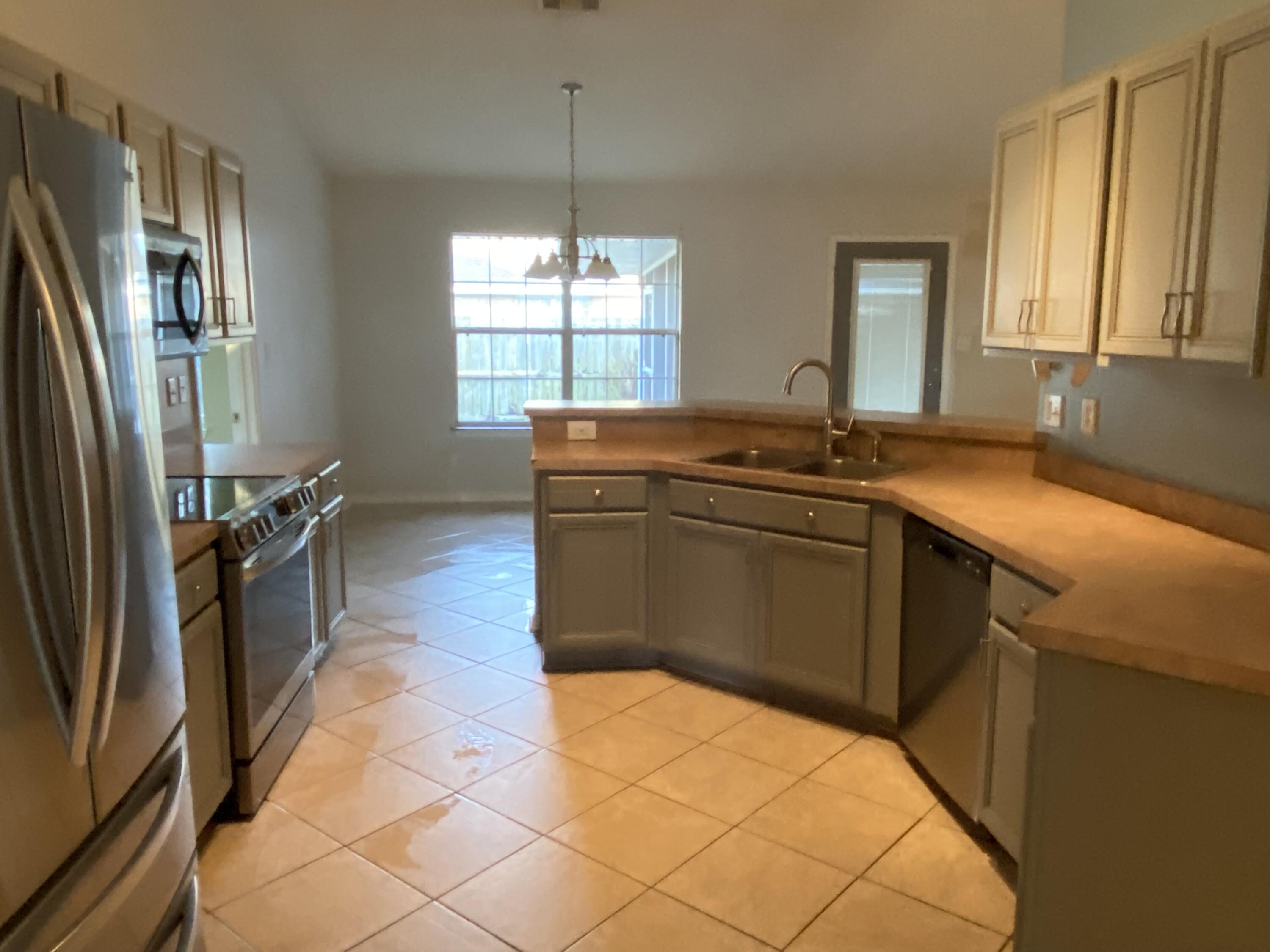 175 Beacon Way Miramar Beach, FL 32550 - Photo 6 of 26 a kitchen with stainless steel appliances granite countertop a sink stove and refrigerator