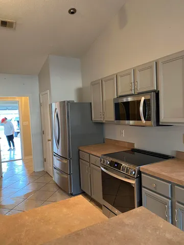 a kitchen with stainless steel appliances granite countertop a stove and a refrigerator