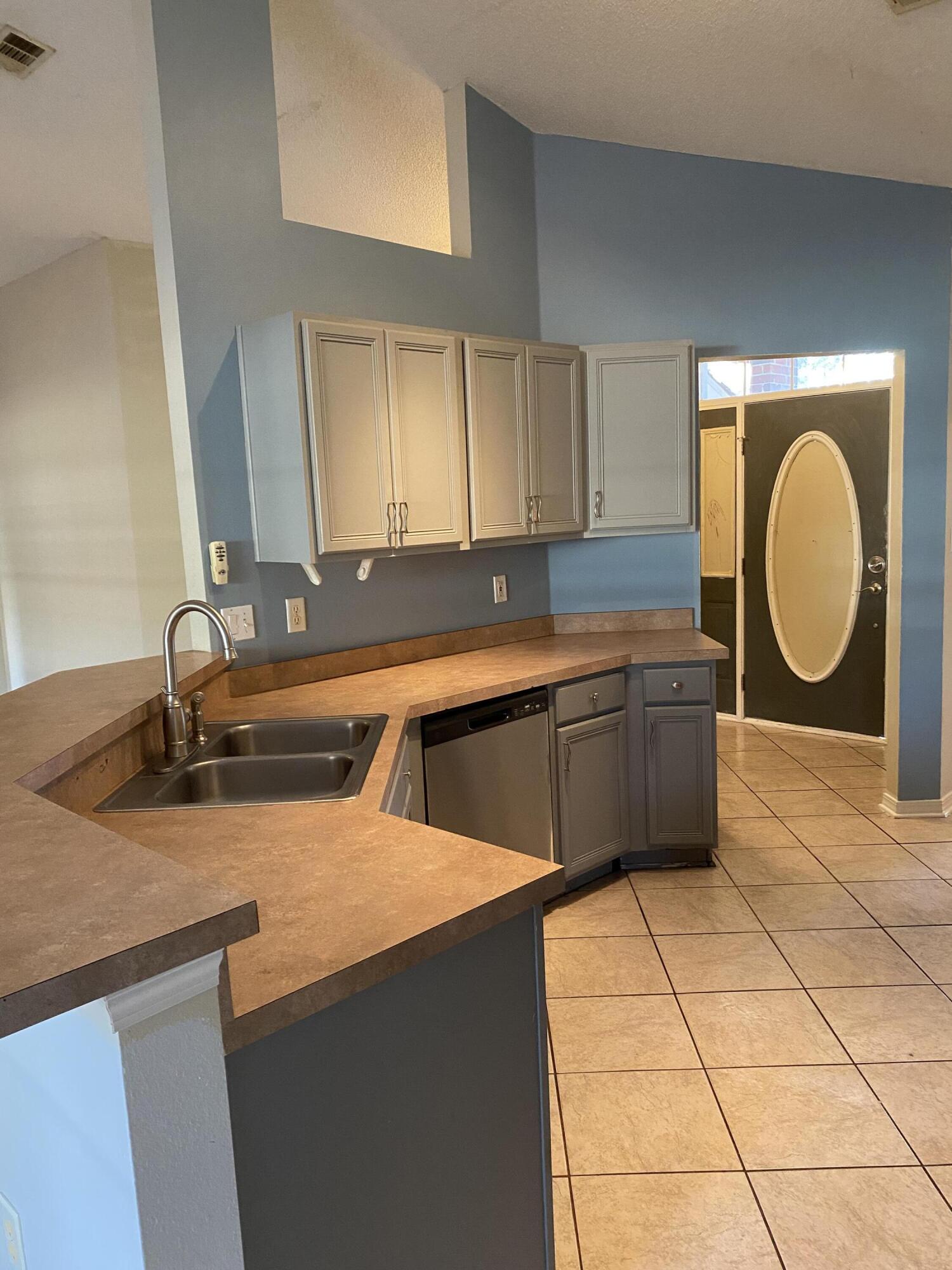175 Beacon Way Miramar Beach, FL 32550 - Photo 8 of 26 a kitchen with a sink a stove and cabinets