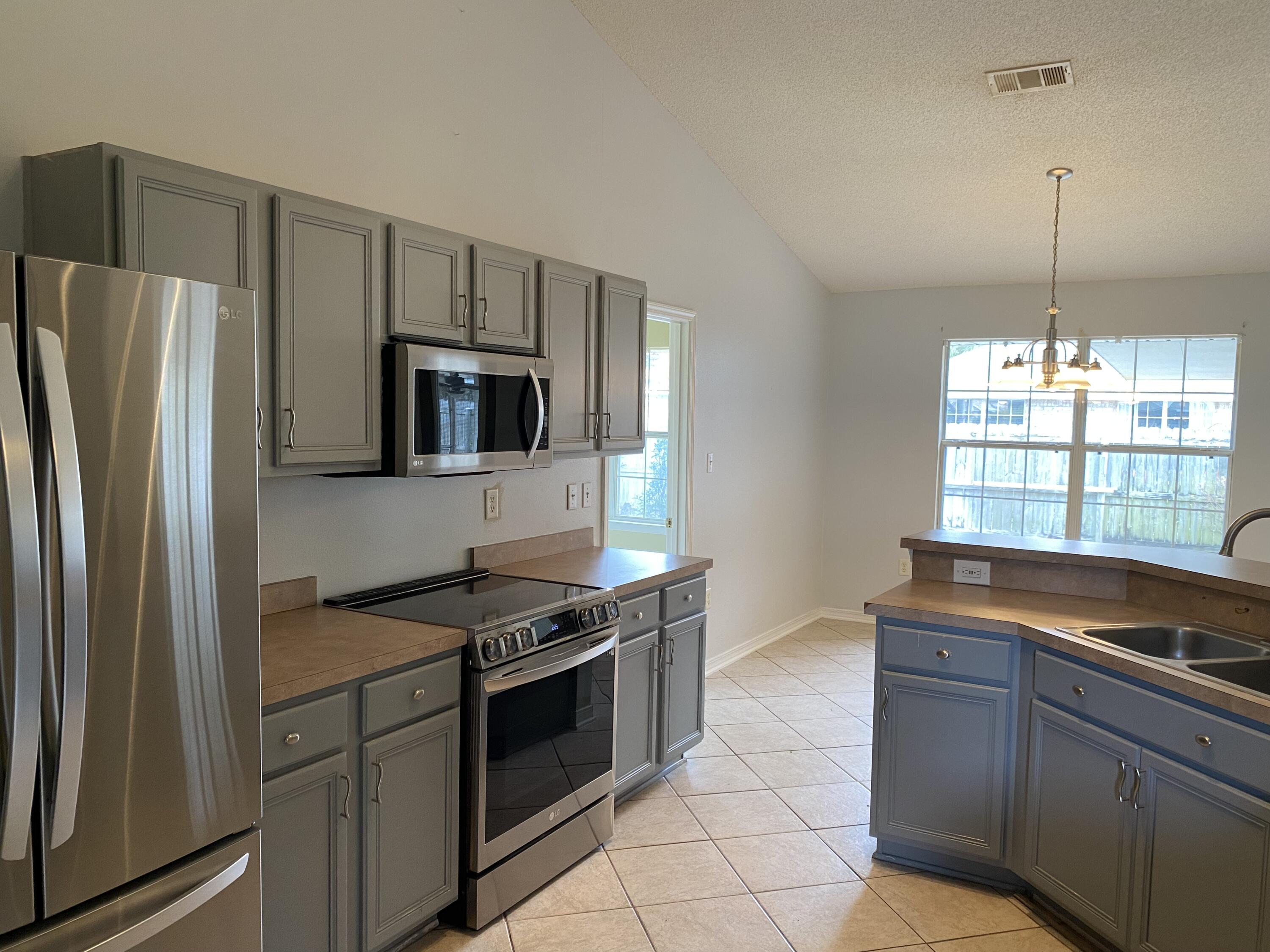 175 Beacon Way Miramar Beach, FL 32550 - Photo 10 of 26 a kitchen with granite countertop a stove and a refrigerator