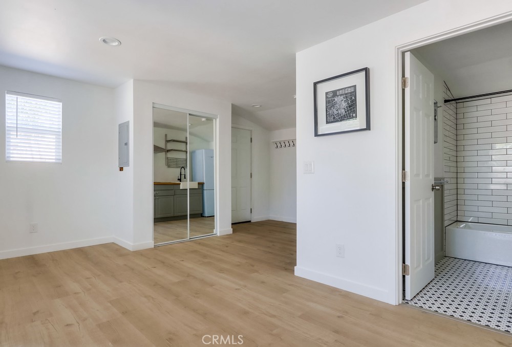 554 South Lemon Street, Unit B Anaheim, CA 92805 - Photo 5 of 10 a view of empty room with wooden floor and cabinet