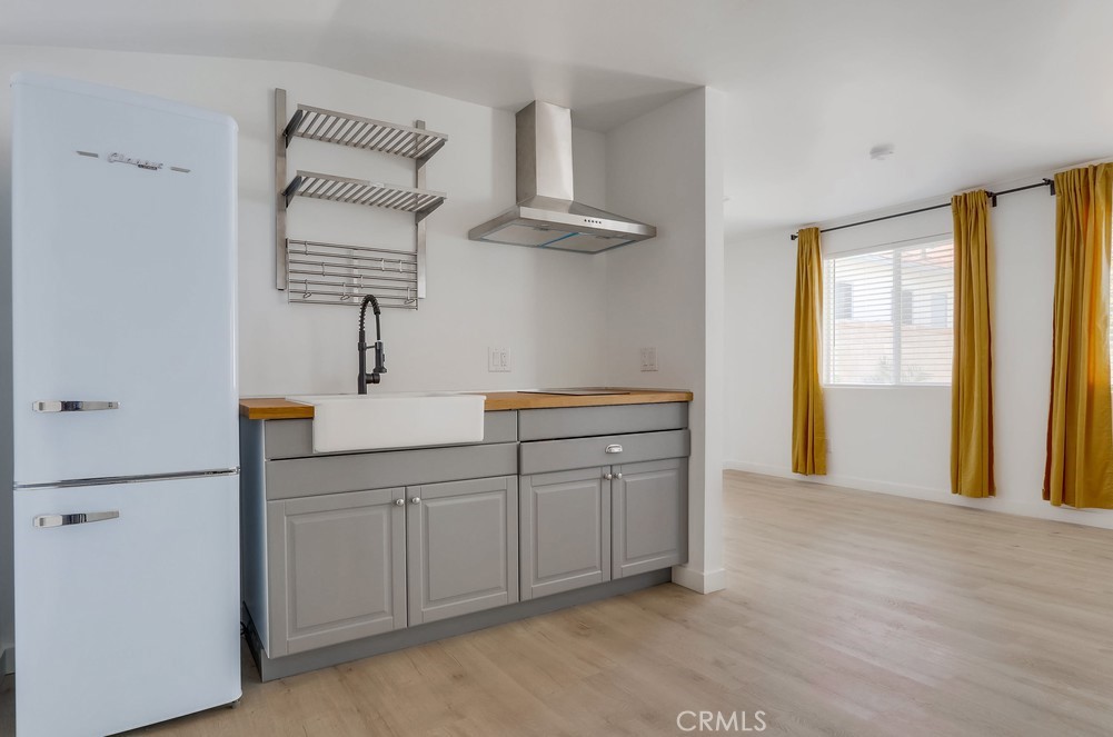 554 South Lemon Street, Unit B Anaheim, CA 92805 - Photo 8 of 10 a kitchen with stainless steel appliances a sink and a refrigerator