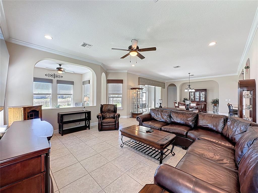 228 Bayou Bend Road Groveland, FL 34736 - Photo 14 of 54 a living room with furniture ceiling fan and a rug