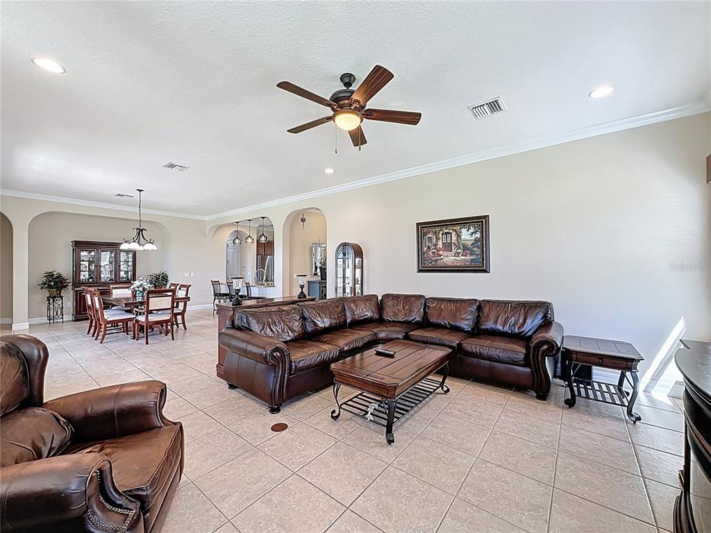 228 Bayou Bend Road Groveland, FL 34736 - Photo 15 of 54 a living room with furniture and a ceiling fan