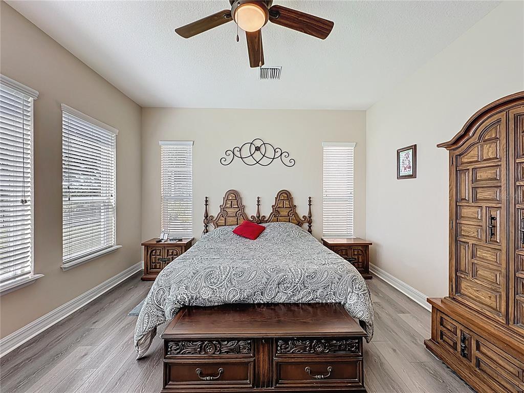 228 Bayou Bend Road Groveland, FL 34736 - Photo 18 of 54 a bedroom with a bed and wooden floor