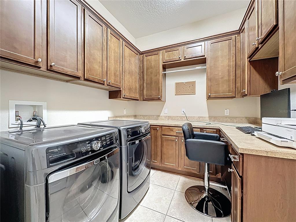 228 Bayou Bend Road Groveland, FL 34736 - Photo 26 of 54 a kitchen with stainless steel appliances granite countertop a stove top oven a sink dishwasher and white cabinets