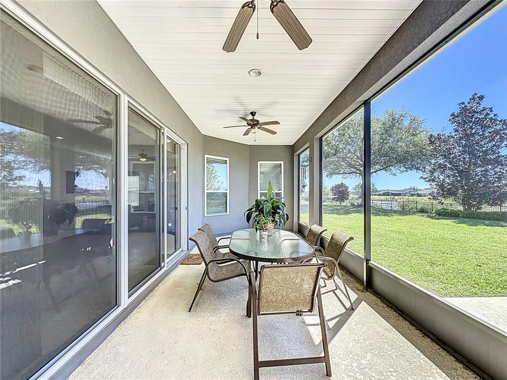 228 Bayou Bend Road Groveland, FL 34736 - Photo 27 of 54 a dining room with furniture and garden view