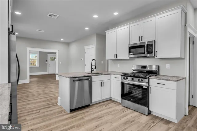 a kitchen with a window and a refrigerator