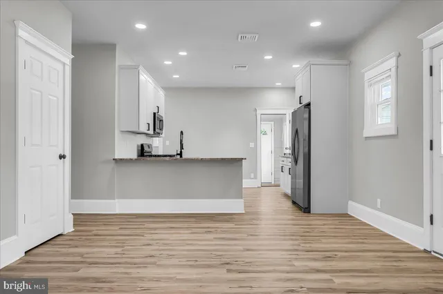 a kitchen with stainless steel appliances granite countertop a refrigerator and a stove