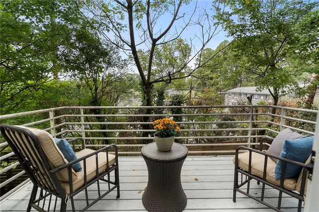a view of a chairs and table in the balcony