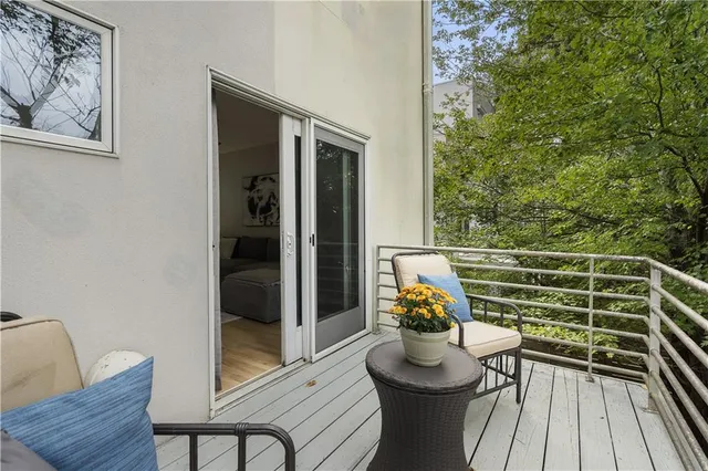 a bathroom with a granite countertop sink a toilet and mirror