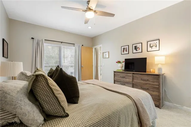 a spacious bedroom with a bed and a chandelier