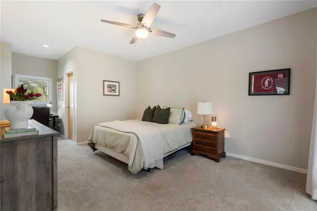 a bedroom with a bed and a television