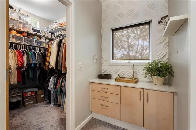 a view of bathroom with a window and a potted plant