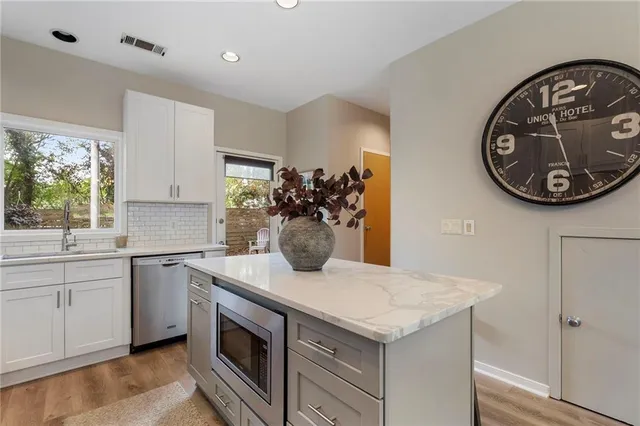 a kitchen with a sink cabinets and a stove