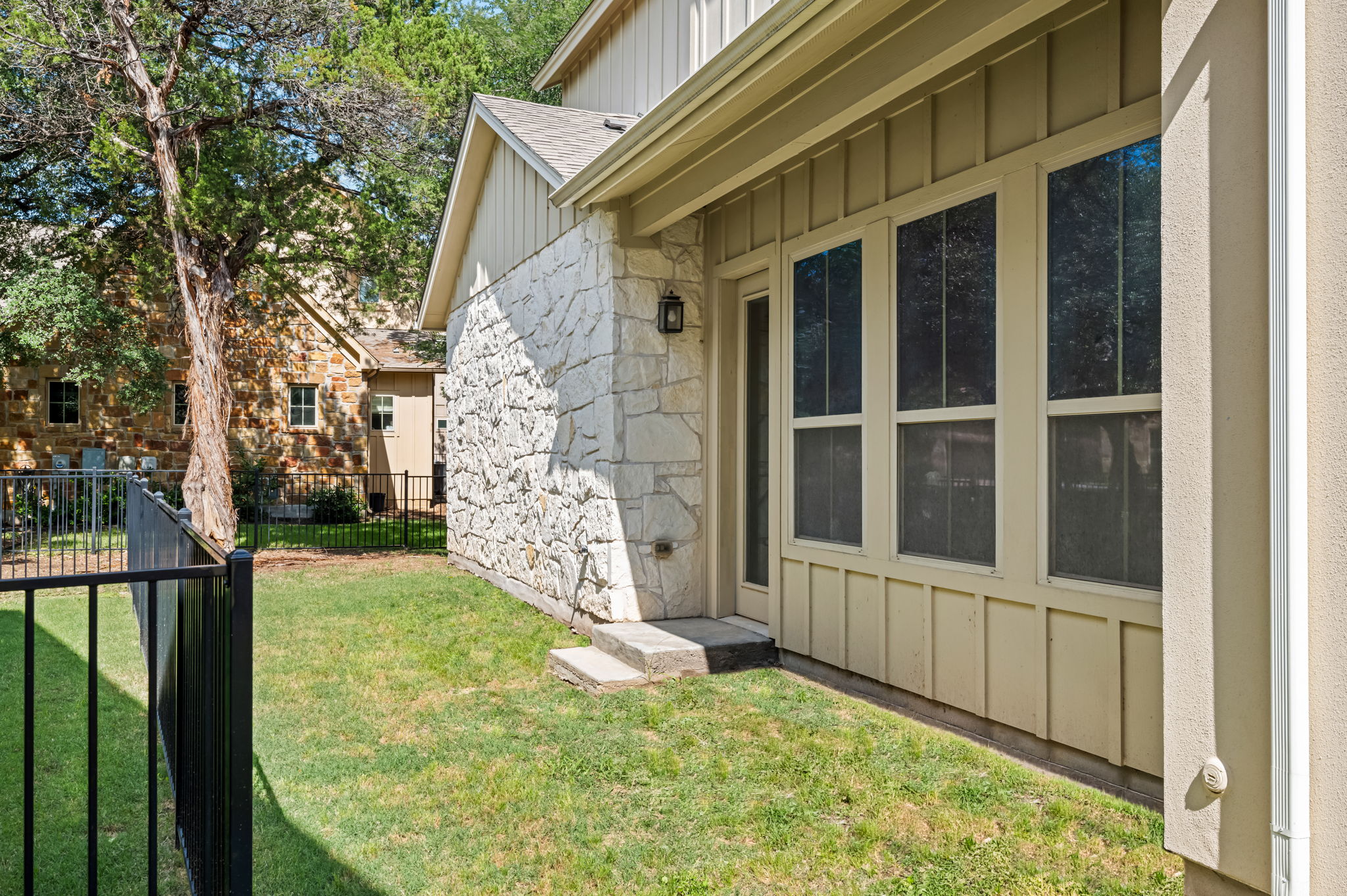2516 Hopsack Mills Road Austin, TX 78748 - Photo 32 of 39 Exterior stone facade with board-and-batten siding and multiple windows