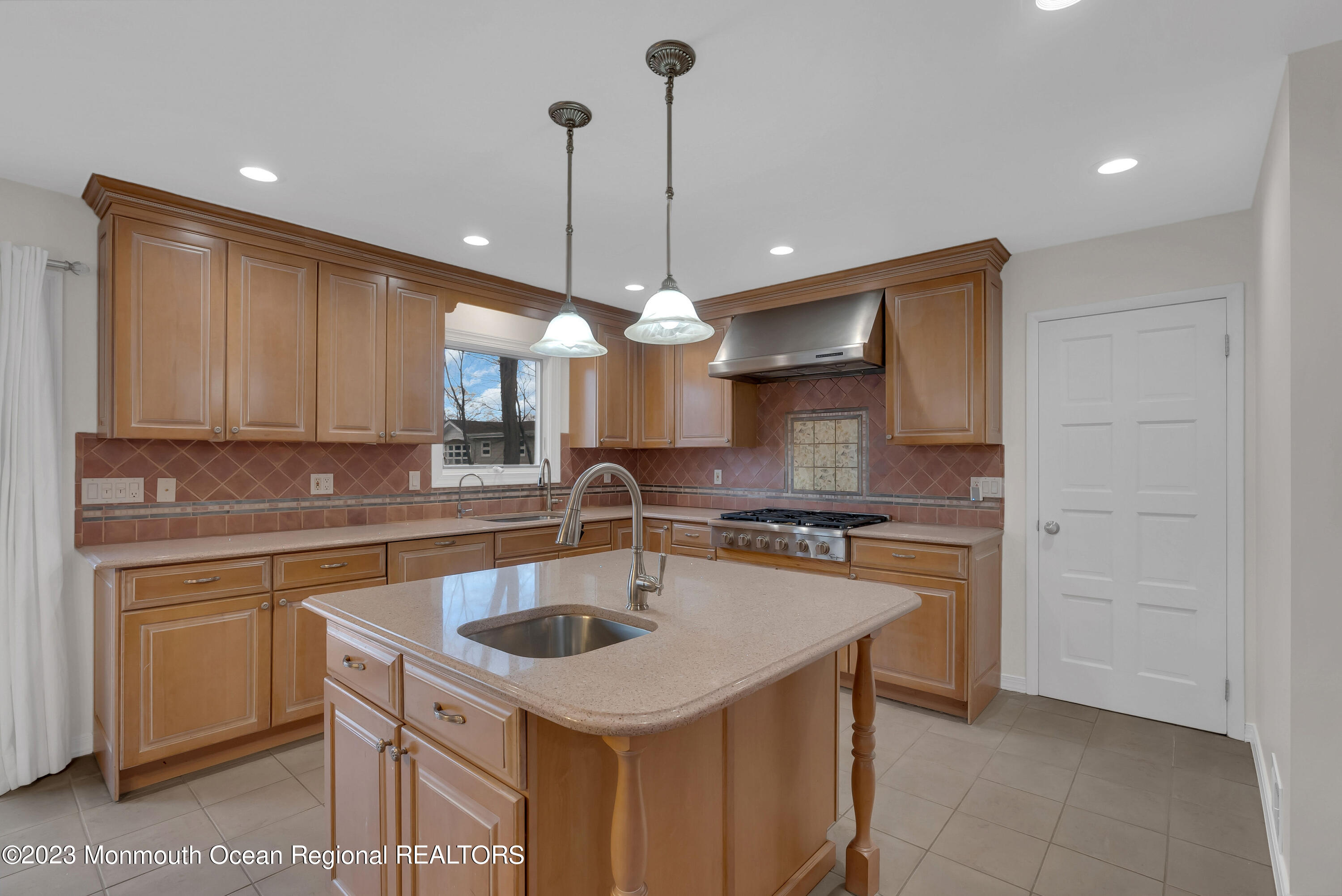 65 Fulton Avenue West Long Branch, NJ 07764 - Photo 9 of 35 a kitchen with a sink a stove a microwave and island