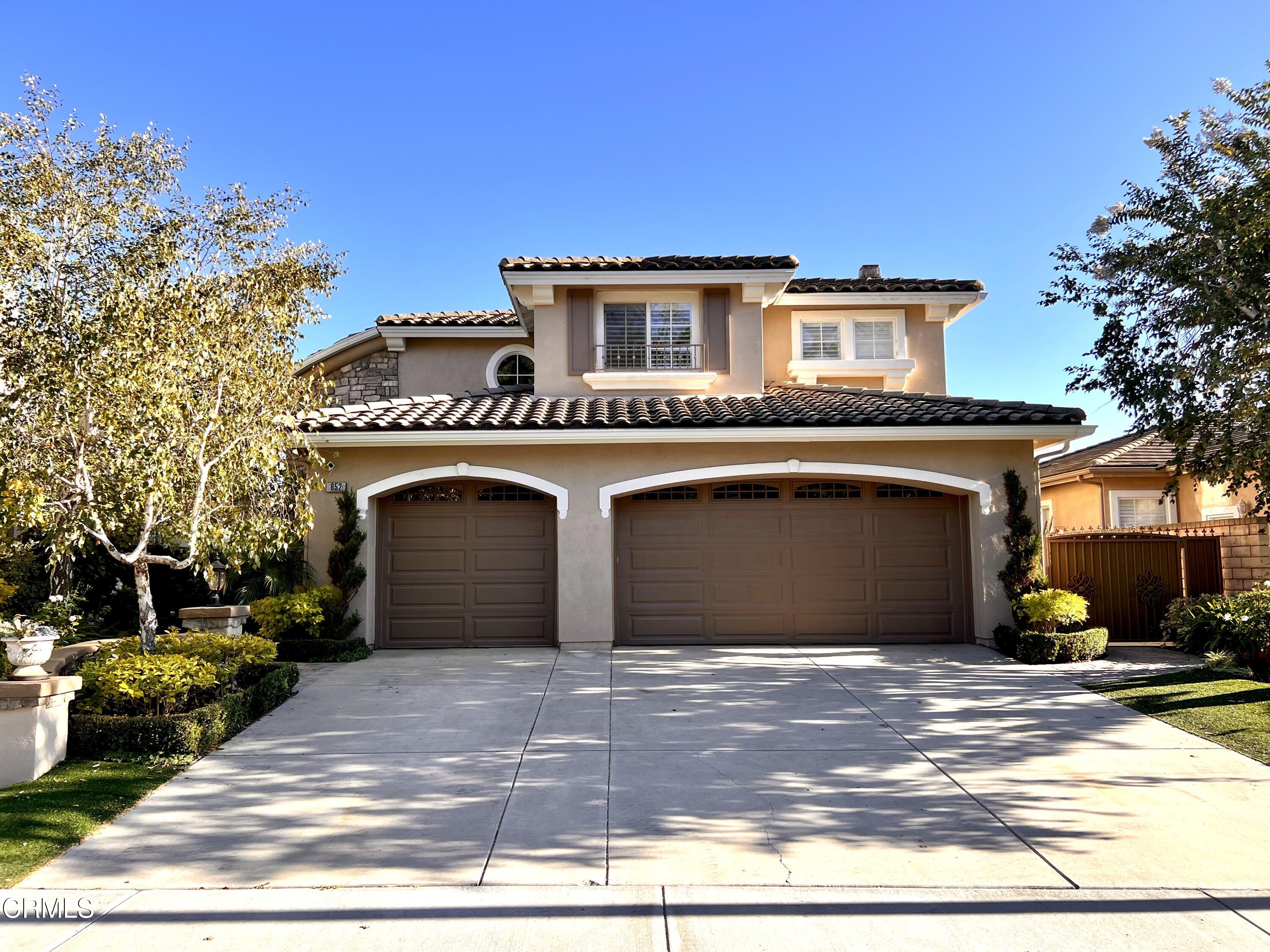 652 Corte Elegante Camarillo, CA 93010 - Photo 2 of 18 a front view of a house with a yard